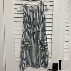 A grey and striped dress. 2 pockets in the front and buttons for style.